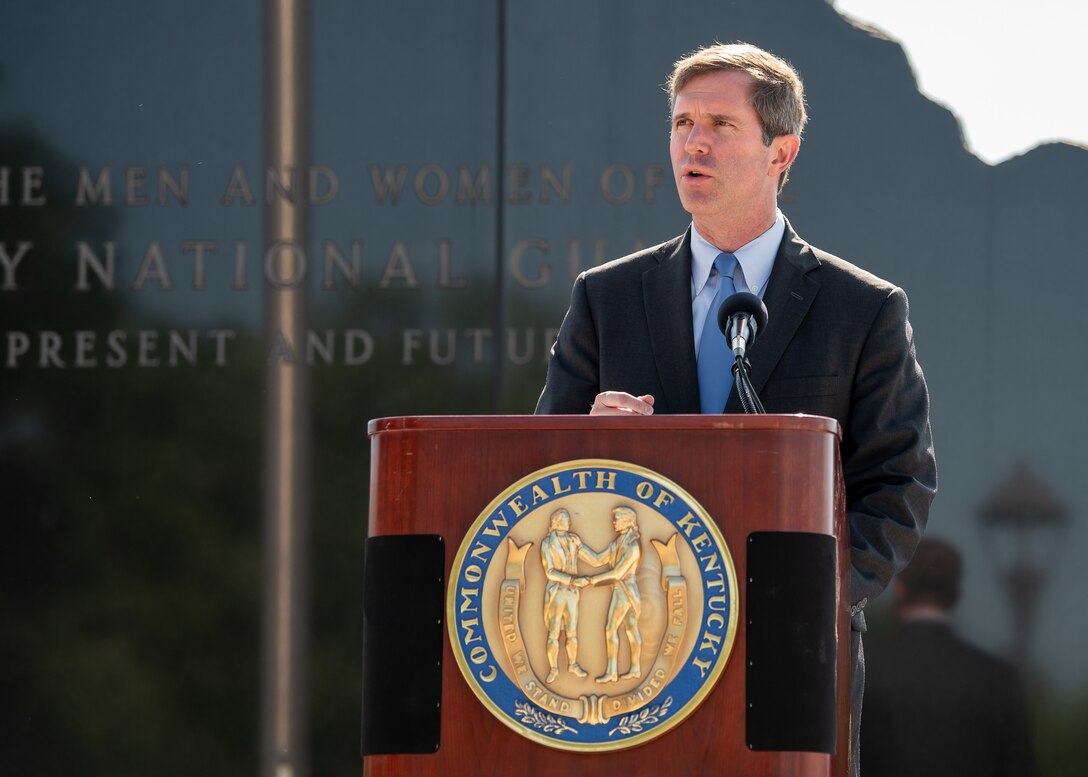 Kentucky Gov. Andy Beshear speaks to the audience at a memorial service held in Frankfort, Ky., May 30, 2022, honoring members of the Kentucky National Guard who have died in the line of duty. The names of 13 Soldiers were added to the Kentucky National Guard Memorial at Boone National Guard Center this year, bringing the total number of fallen Airmen and Soldiers to 286. (U.S. Air National Guard photo by Dale Greer)