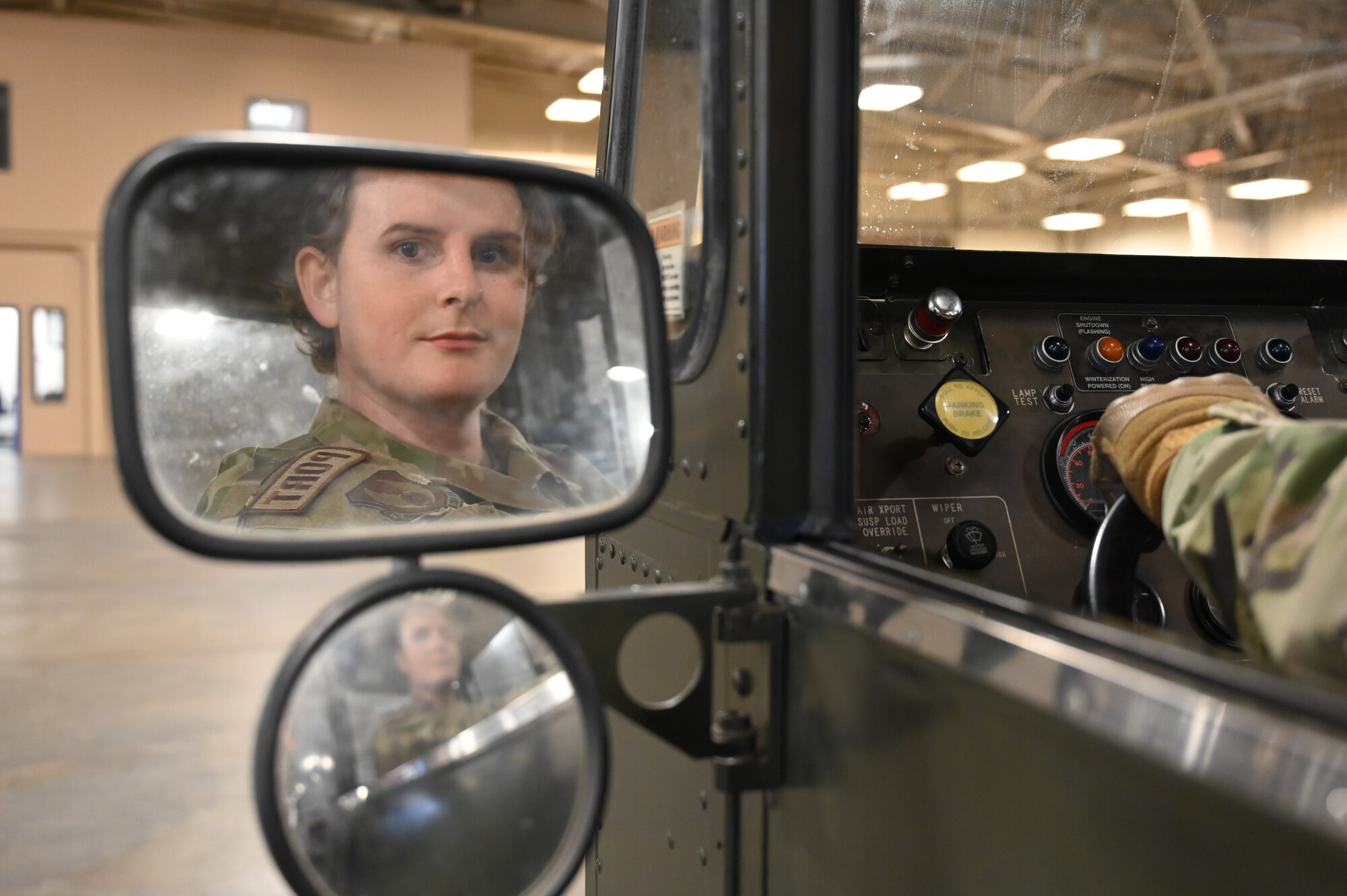SSgt. Bryan Tisdale looks in mirror while driving a K-Loader.