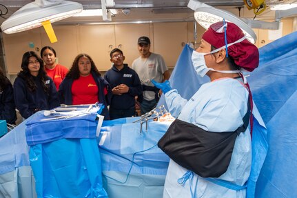 Hospital Corpsman 1st Class Riafel Marte gives a public tour of medical facilities aboard the San Antonio-class amphibious transport dock ship USS Portland (LPD 27) during Los Angeles Fleet Week, May 27, 2022.