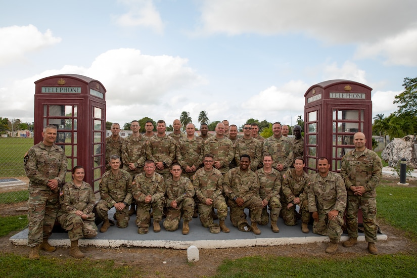 Kentucky National Guard's Headquarters and Headquarters Detachment (HHD), 75th Troop Command poses for a group photo at the end of Operation Tradewinds 2022 at Price Barracks, Belize on May 20, 2022. HHD, 75th Troop Command provided brigade level support to Tradewinds 22, a multinational exercise designed to expand the Caribbean region’s capability to mitigate, plan for and respond to crises; increase regional training capacity and interoperability; develop new and refine existing standard operating procedures (SOPs); enhance ability to defend exclusive economic zones (EEZ); and promote human rights and adherence to shared international norms and values; fully integrate women into defense, peace and security missions; and increase maritime domain awareness to deter illegal, unregulated and unreported fishing activities (U.S. Army photo by Staff Sgt. Andrew Dickson).