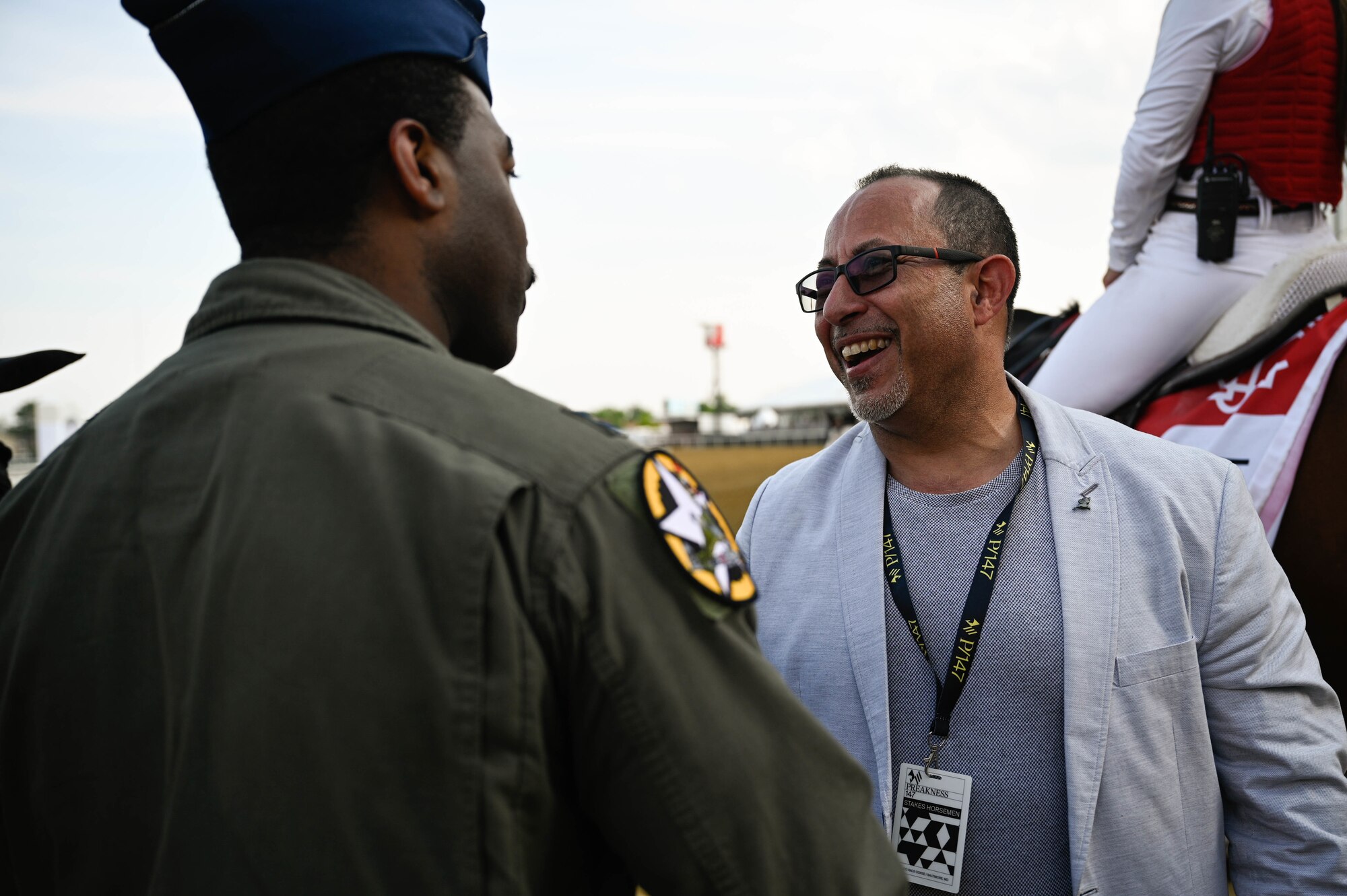 A U.S. Air Force B-2 Spirit pilot talks to Preakness Stakes attendees at the Pimlico race course, Baltimore, Maryland, May 21, 2022. The Preakness Stakes is an American thoroughbred horse race held on the third Saturday in May each year in Baltimore, Maryland.