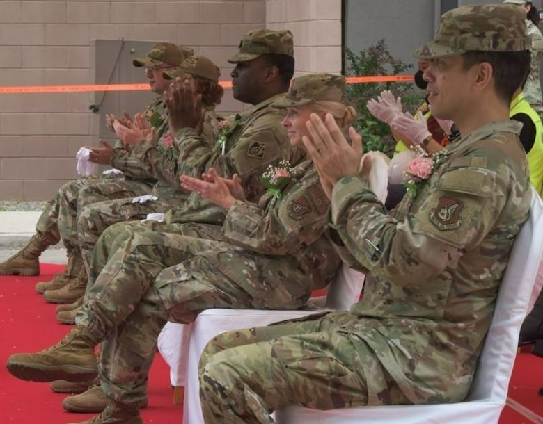 Distinguished guests applaud Col. Elizabeth Eychner, 51st Mission Support Group commander, and Lt. Col. Michael Williams, 51st Communications Squadron commander, after their speech during the 51st Communications Squadron Headquarters Facility Groundbreaking Ceremony at Osan Air Base, May 25. (Courtesy photo)