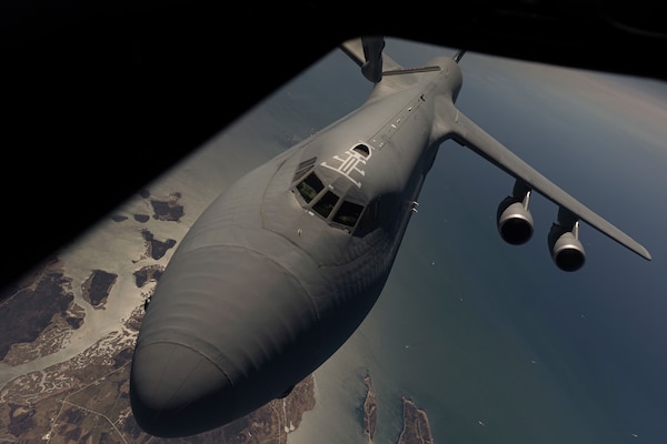 An Air Force C-5M Super Galaxy flies behind a KC-135R Stratotanker for a refueling over Nova Scotia, Canada, April 15, 2021.