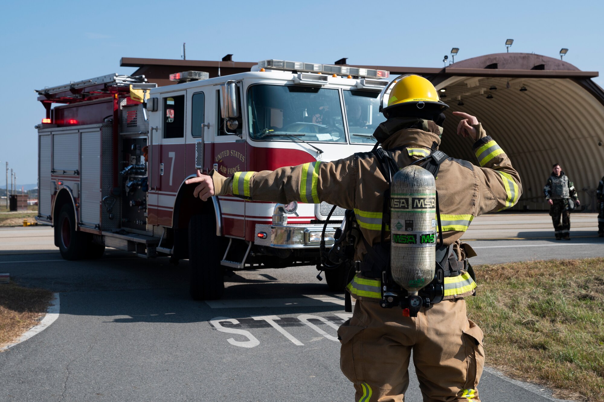U.S. Air Force 51st Civil Engineer Squadron fireman guides a fire truck around a narrow road during a training event as part of Vigilant Storm 23 at Osan Air Base, Republic of Korea, Oct. 31, 2022.