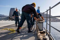 Sailors assigned to the Ticonderoga-class guided-missile cruiser USS Leyte Gulf (CG 55) secure line from a tugboat as the ship pulls into Dubrovnik, Croatia, for a scheduled port visit, Oct. 31, 2022.