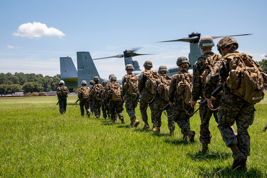 Naval Reserve Officer Training Corps (NROTC) Midshipmen prepare to board an MV-22B Osprey for an air insert exercise during their Summer Training Program at Marine Corps Base Camp Lejeune, N.C., August 2, 2022. NROTC Midshipmen Summer Training develops and trains Midshipmen in order to provide the Fleet a competent and professional Naval Service Commissioned Officer. (U.S. Marine Corps photo by Lance Cpl. Nicholas Guevara)