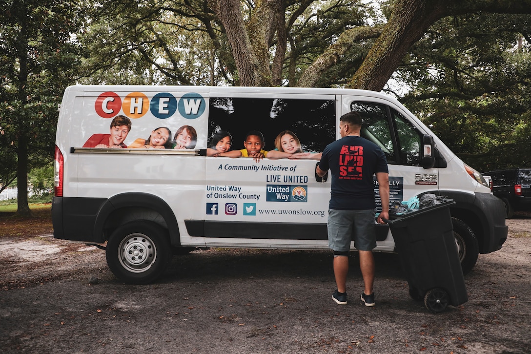 RP2 Victor Rosario, religious program specialist of the 24th Marine Expeditionary Unit (MEU), loads food into a van for delivery at a community relations event in Jacksonville, N.C.