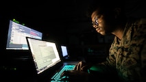 U.S. Marine Corps Lance Cpl. Ram Francis, a data systems administrator with Headquarters Battalion, 23rd Marine Regiment, monitors network traffic and activity on Fort Pickett, Virginia, Feb. 6, 2022. Marine Corps Systems Command recently launched the Technical Management and Analysis Directorate – or TMAD – in a drive to modernize the Marine Corps Enterprise Network, or MCEN. The Marine Corps Enterprise Network, or MCEN, is an interconnected “network of networks” that links service personnel, architecture, processes, physical and logical topology, and cyber operations.  (U.S. Marine Corps photo by Cpl. James Stanfield)