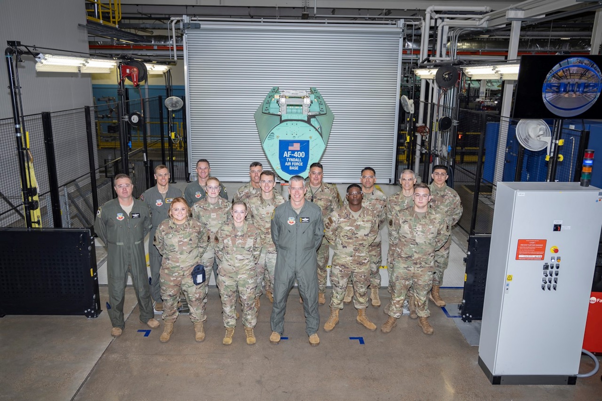 U.S. Airmen assigned to Tyndall Air Force Base, Florida, pose together in front of an F-35A Lightning II airframe structural component at the Lockheed Martin factory in Fort Worth, Texas, Oct. 20, 2022.