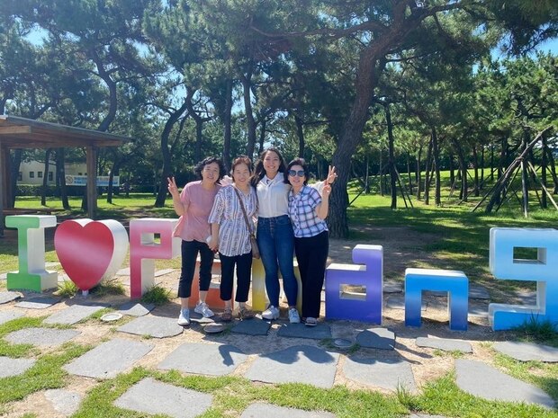U.S. Marine Corps Capt. Tiana Winstead, a defense attorney with Headquarters Battalion, 3rd Marine Logistics Group, poses for a photo with her family in PoHang, South Korea, Sep. 2022. Winstead was in Korea for exercise Ulchi Freedom Shield and was reconnected with her extended family.