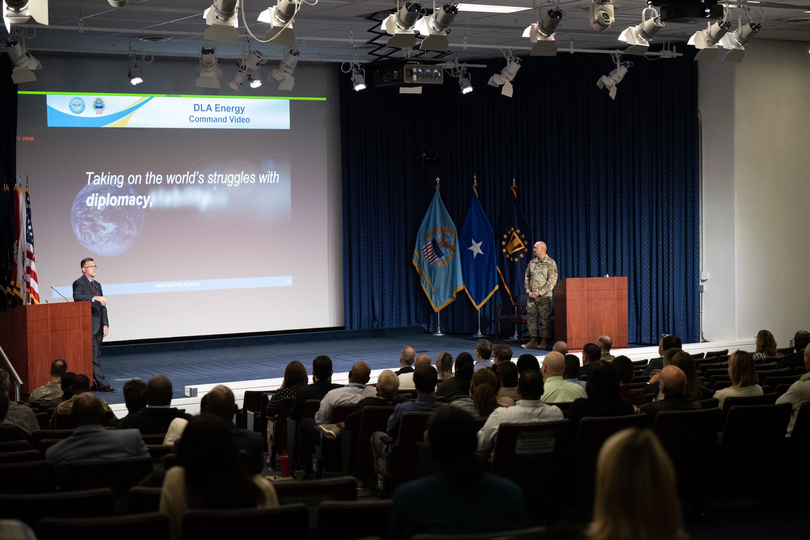 DLA Energy Commander Air Force Brig. Gen. Jimmy Canlas and DLA Energy Deputy Commander David Kless on stage