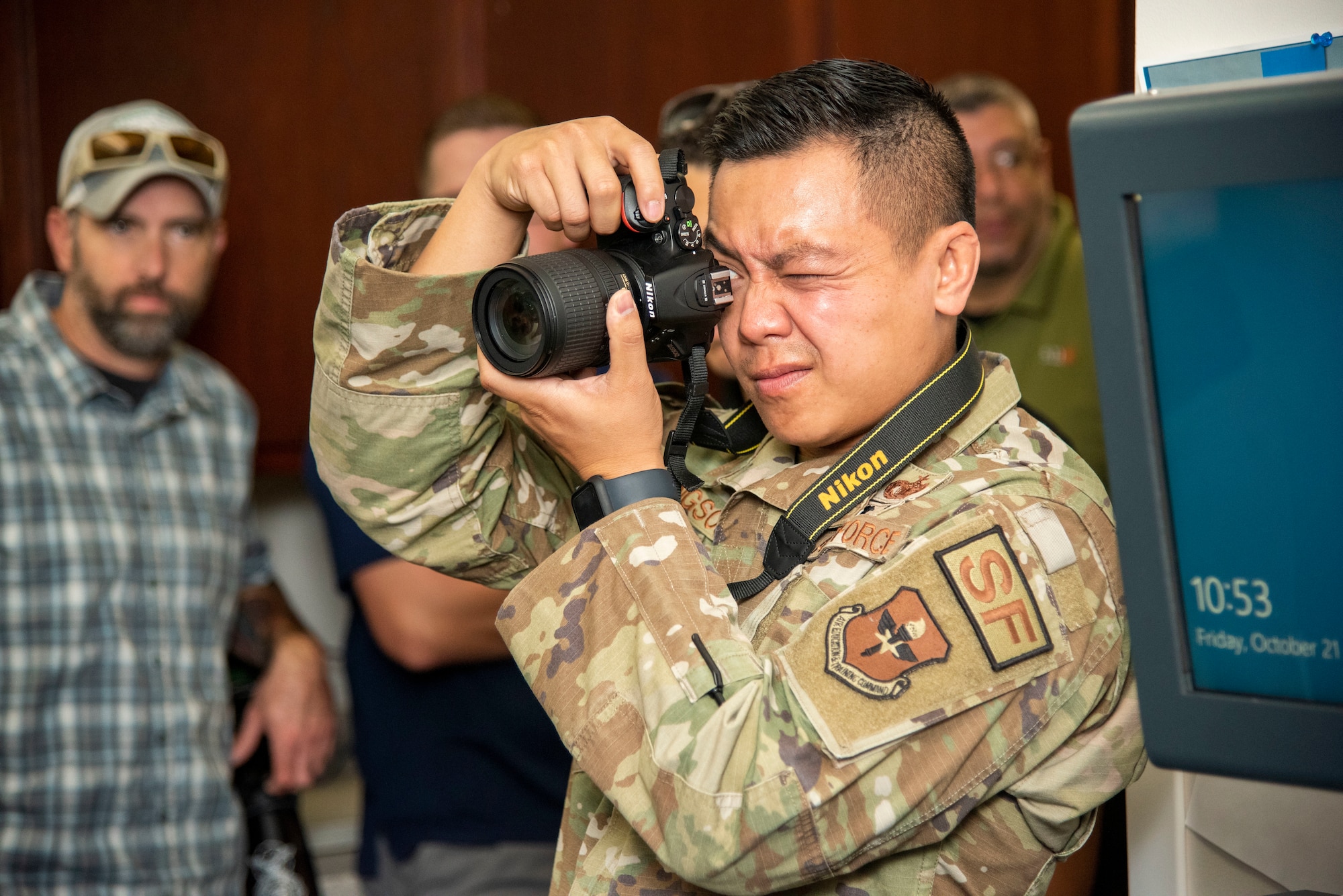 Tech. Sgt. Jesse Sengsouk, of the 502nd Security Forces Squadron who is preparing to become an OSI Agent, practices taking photos at a simulated investigation scene Oct. 21, 2022, at Joint Base San Antonio-Fort Sam Houston, Texas. (U.S. Air Force photo by Kara Carrier)