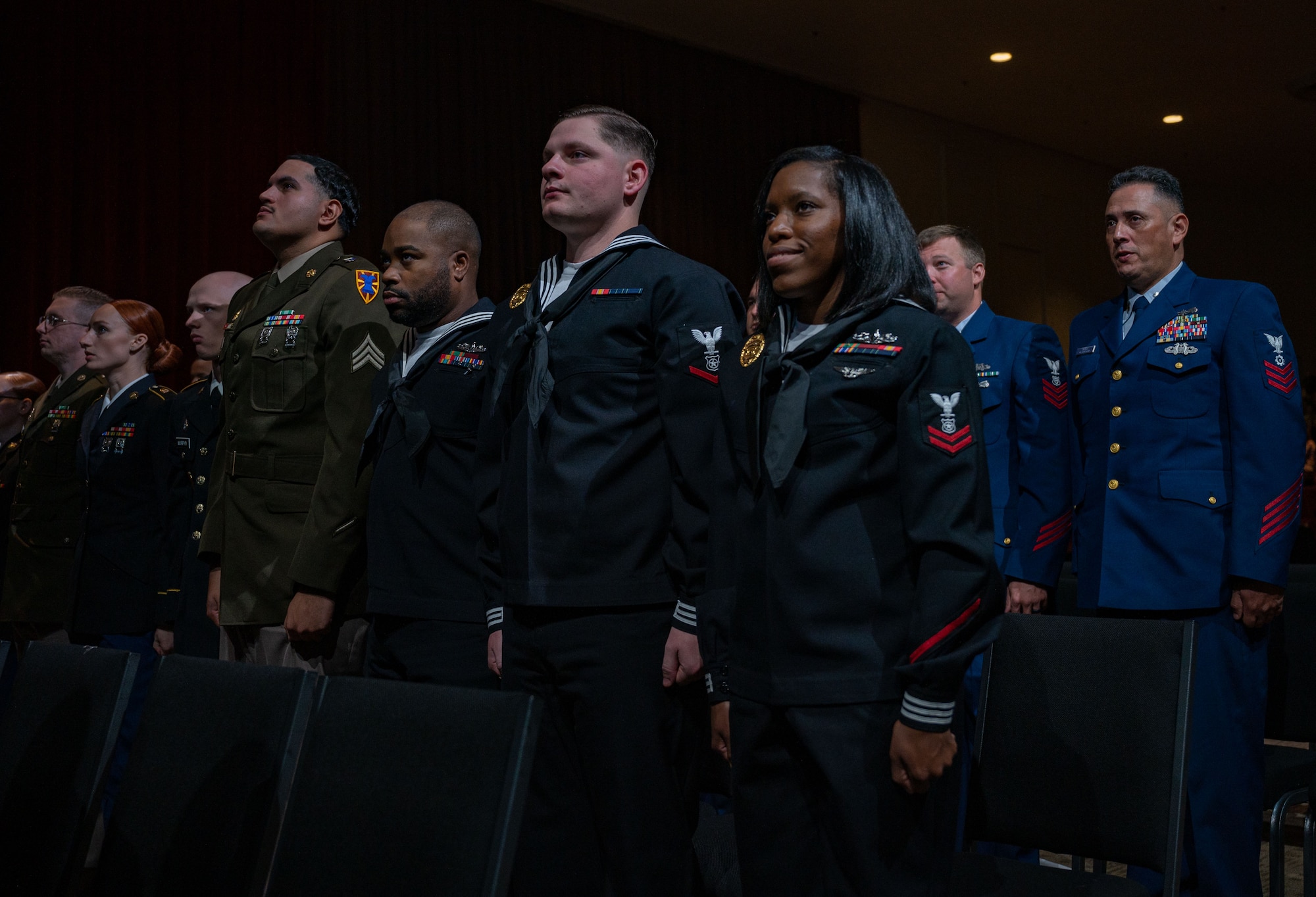 NCOs stand together at attention