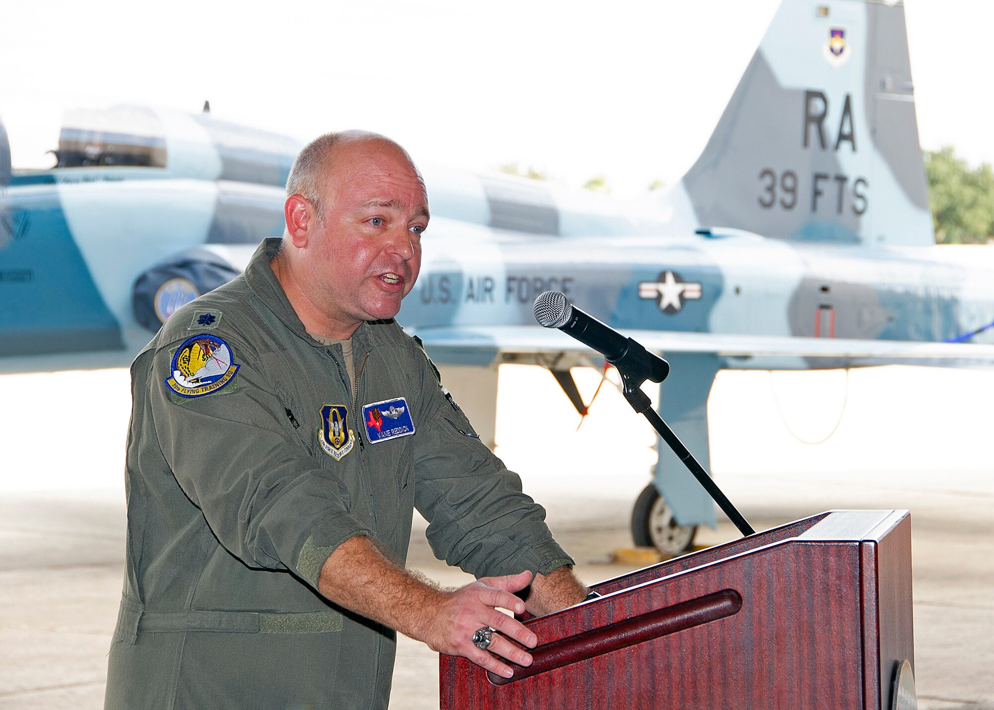 Lt. Col. Thad Reddick addresses guests, attendees, and personnel