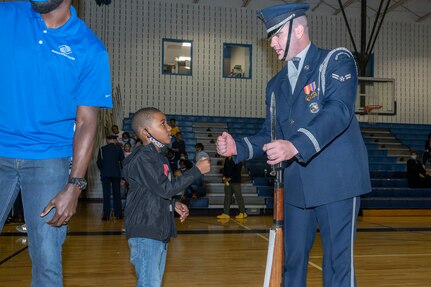 Airman 1st Class Blake Hardy of the U.S. Air Force Honor Guard Drill Team greets Boys & Girls Clubs of Greater Washington member Karson Avents Oct. 25, 2022, Washington, D.C. Joint Base Anacostia-Bolling strives to create partnerships and engage with the community throughout the National Capital Region. (U.S. Air Force photo by Jason Treffry)