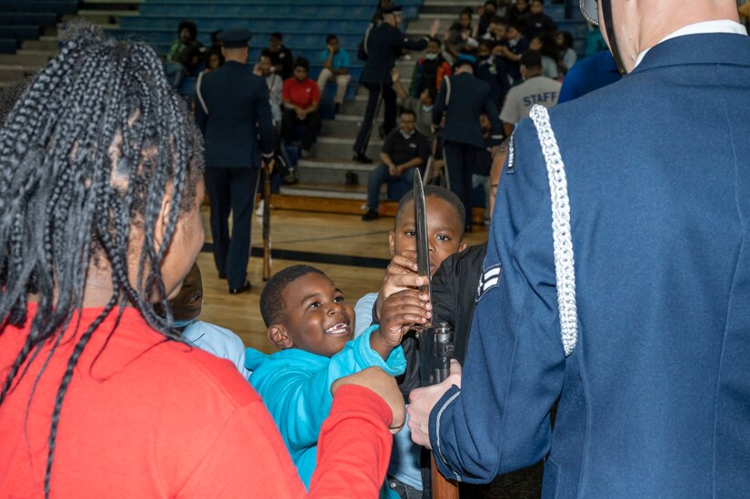 Jabari Blackmon and Chance Yelverton interact with members of the U.S. Air Force Honor Guard Drill Team after a performance for Boys & Girls Clubs of Greater Washington Oct. 25, 2022, Washington, D.C. Joint Base Anacostia-Bolling strives to create partnerships through community engagement events across the National Capital Region. (U.S. Air Force photo by Jason Treffry)