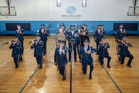 U.S. Air Force Lt. Col. Ryan Zeitler, vice commander of JBAB and the 11th Wing, and Gabrielle Webster, Boys & Girls Clubs of Greater Washington president & CEO, post for a photo with members of The United States Air Force Honor Guard Drill Team after a performance Oct. 25, 2022, Washington, D.C. Webster is Honorary Commander to the U.S. Air Force Honor Guard. (U.S. Air Force photo by Jason Treffry)