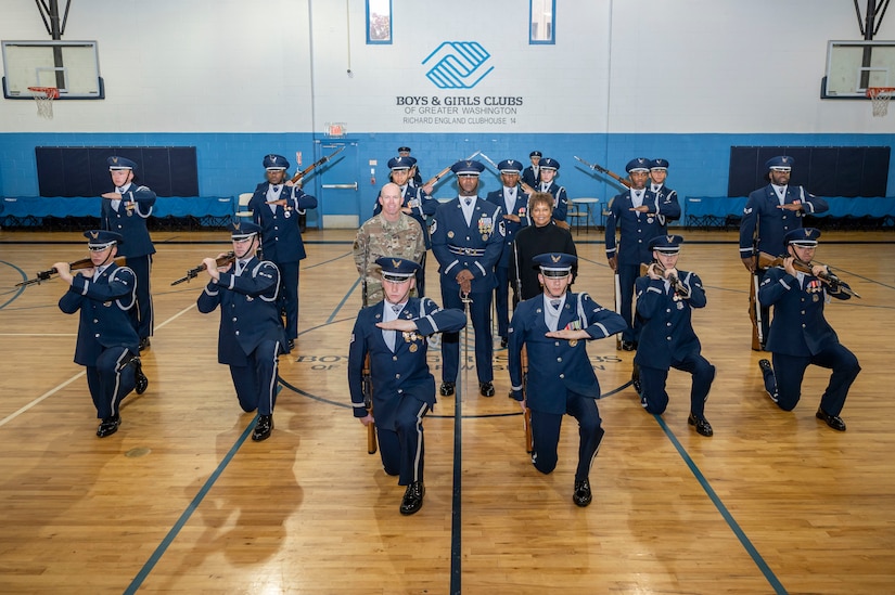 U.S. Air Force Lt. Col. Ryan Zeitler, vice commander of JBAB and the 11th Wing, and Gabrielle Webster, Boys & Girls Clubs of Greater Washington president & CEO, post for a photo with members of The United States Air Force Honor Guard Drill Team after a performance Oct. 25, 2022, Washington, D.C. Webster is Honorary Commander to the U.S. Air Force Honor Guard. (U.S. Air Force photo by Jason Treffry)