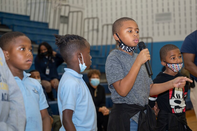 Boys & Girls Clubs of Greater Washington member Kyan Avents asks a question to members of the U.S. Air Force Honor Guard Drill Team after a performance Oct. 25, 2022, Washington, D.C. Joint Base Anacostia-Bolling strives to create partnerships through community engagement events across the National Capital Region. (U.S. Air Force photo by Jason Treffry)