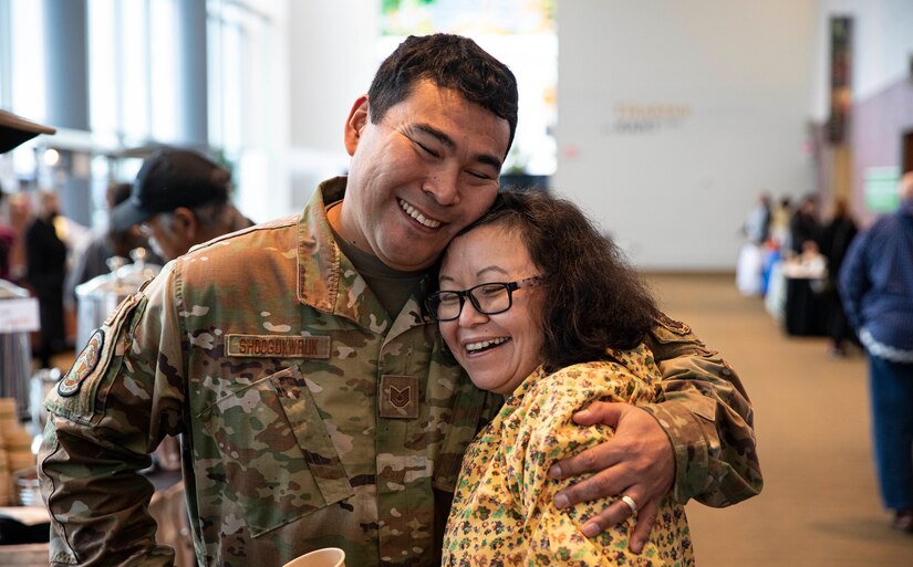 Tech. Sgt. Blassi Shoogukwruk, a C-17 Globemaster III crew chief with the 176th Aircraft Maintenance Squadron hugs his cousin, Patti Oksoktaruk Lillie during the First Alaskans Institute Elder and Native Youth conference held in Anchorage, Alaska, Oct. 18, 2022. The conference gives Alaska Native youth opportunities to meet with elders in their communities and learn how to advocate for themselves and their people as well as connect with others. (Alaska National Guard photo by Staff Sgt. Katie Mazos-Vega)