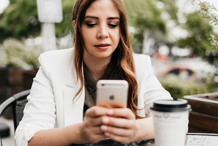 A woman checks her cell phone