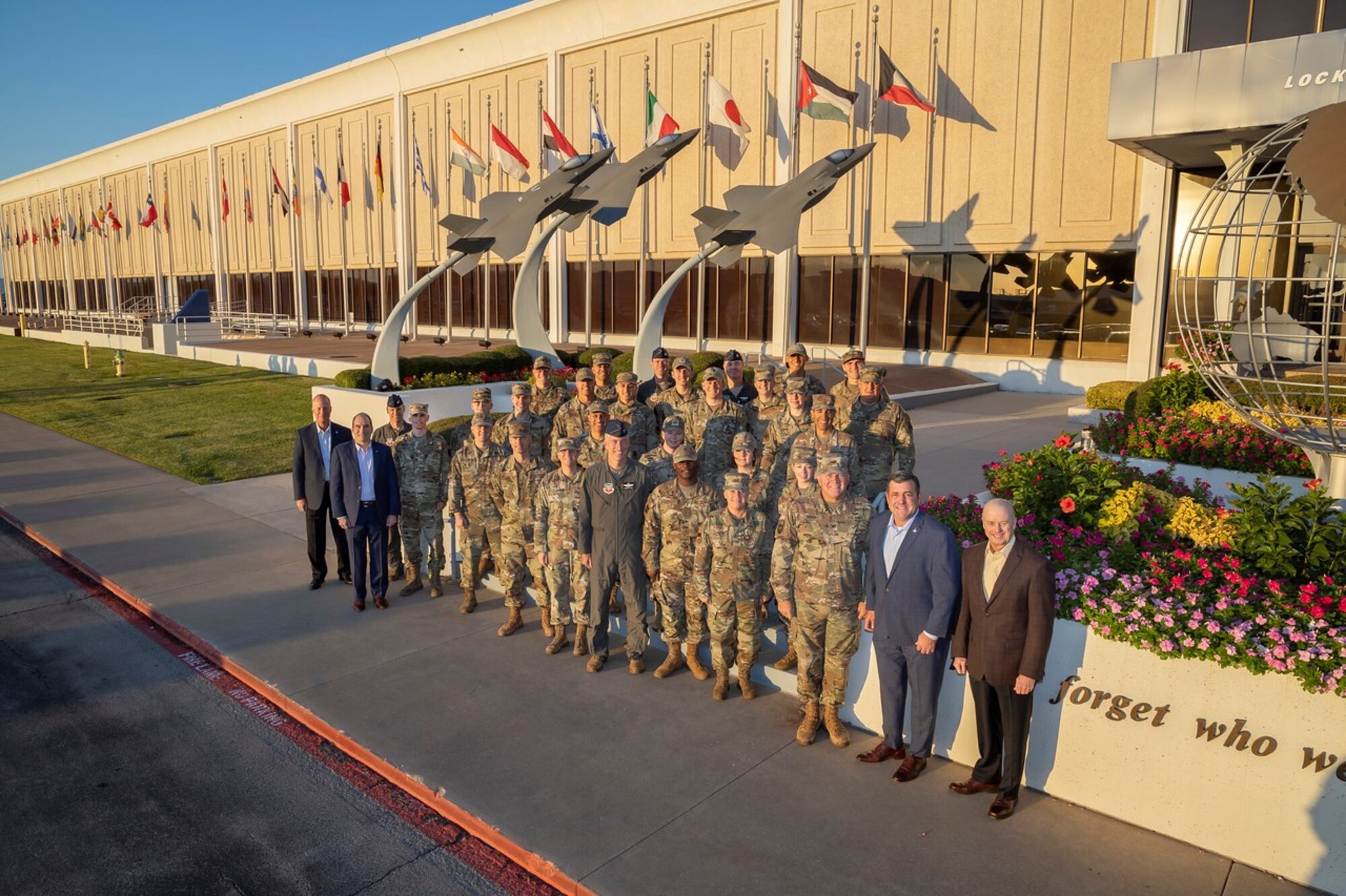 U.S. Airmen assigned to Tyndall Air Force Base, Florida, and members of the Lockheed Martin F-35 Lightning II team, pose for a photo outside the Lockheed Martin factory in Fort Worth, Texas, Oct. 20, 2022.