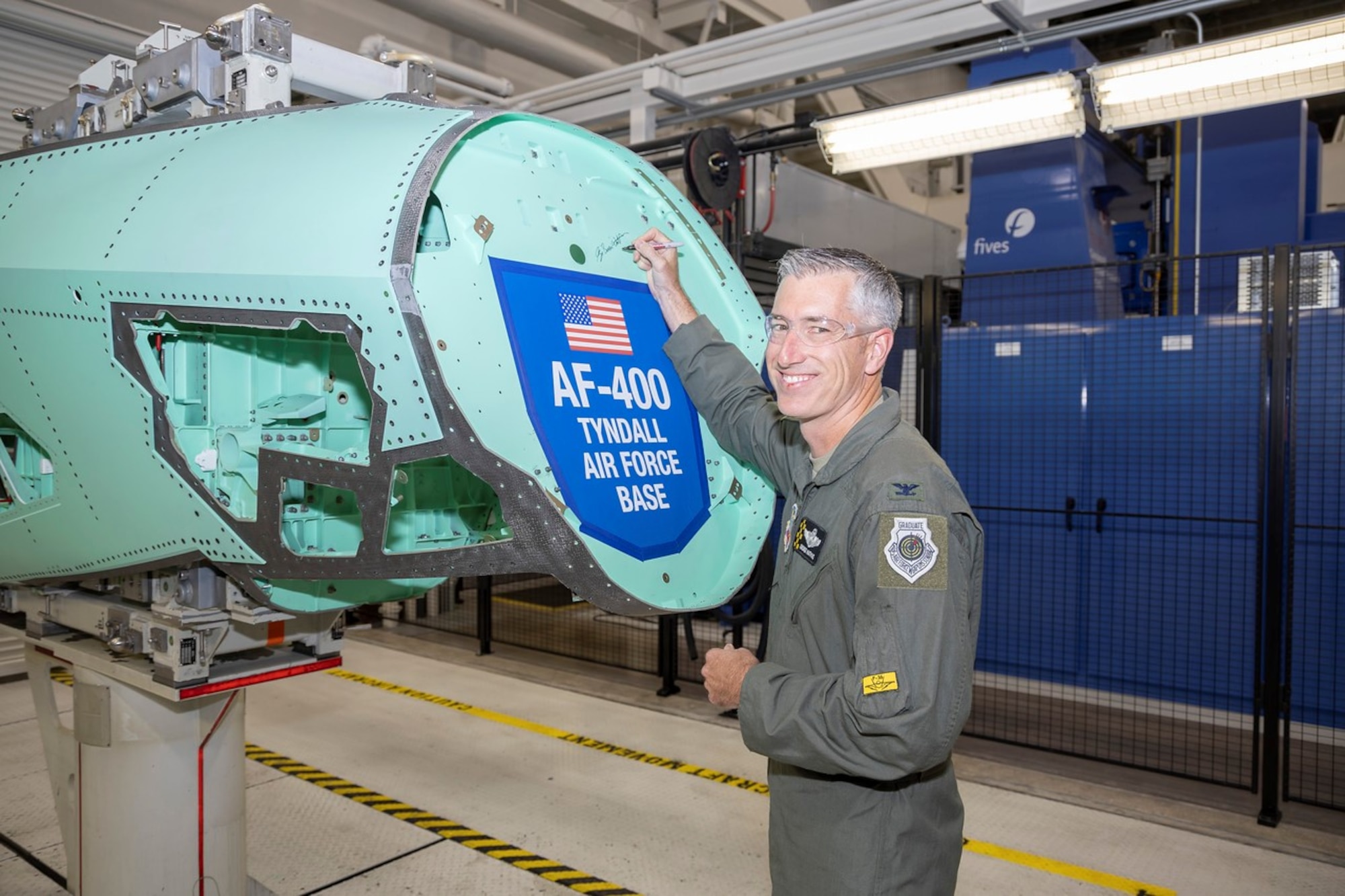 U.S. Air Force Col. George Watkins, 325th Fighter Wing commander, signs an F-35A Lightning II airframe structural component at the Lockheed Martin factory in Fort Worth, Texas, Oct. 20, 2022.
