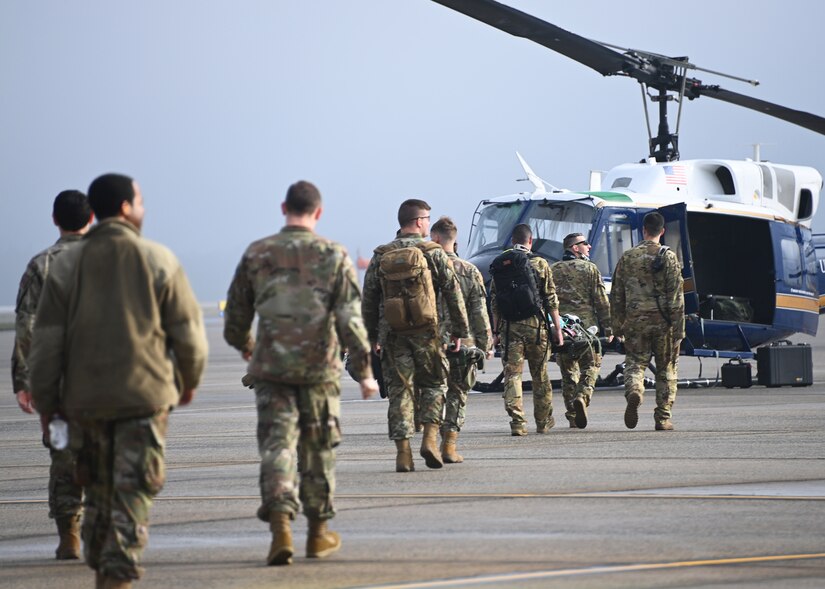 Members of the 316th Wing Critical Care Air Transport Teams walk towards a UH-1N Huey for highly specialized training exercises at Joint Base Andrews, Md., Nov. 1, 2022. CCATTs are composed of a physician, an intensive care unit nurse, and a respiratory therapist.