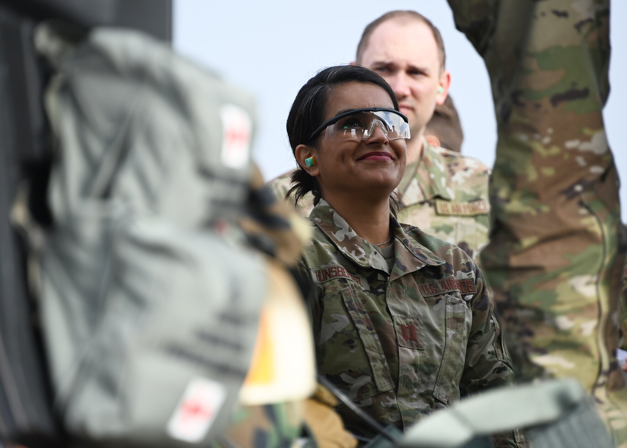 Capt. Dominique Hunsberger, 316th Health Care Operations Squadron intensive care unit nurse, listens to in-flight training procedures before take off at Joint Base Andrews, Md., Nov. 1, 2022. This static and in-flight readiness training prepares Airmen for the unpredictability of war, adapting in regulated and unregulated environments, as well as adapting their skills for in-garrison air evacuation care when needed.