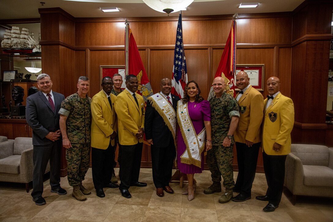 The newly elected King and Queen of Zulu for Mardi Gras 2023, Mr. Nick Spears and Dr. Christy Spears, center, Lt. Gen. David G. Bellon, right, Commanding General of Marine Forces Reserve and Marine Forces South, and Brig. Gen. Kevin G. Collins, left, Deputy Commander of Marine Corps Reserve and Marine Forces South, along with Member of the Zulu Social Aid and Pleasure Club, pose for a group photo Oct. 20, 2022 at Marine Corps Support Facility New Orleans. The King and Queen of Zulu are part of the Zulu Social Aid and Pleasure Club that actively participate in the local communities and Mardi Gras. Each year, a new King and Queen of Zulu is elected from organizational members to honor the commitment and dedication of one of their longstanding colleagues. (U.S. Marine Corps photo by Cpl. Trystan Taft)