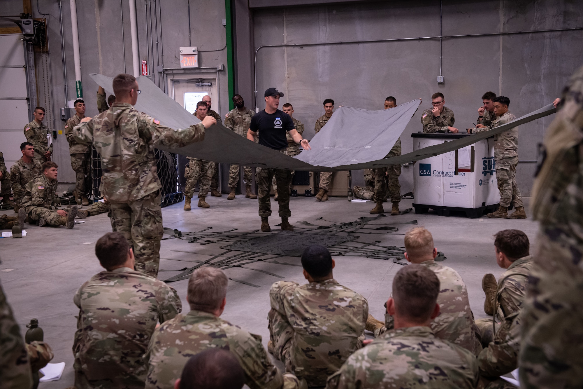 A U.S. Army Air Assault instructor teaches students the proper techniques on preparing equipment and supplies for sling load operations August 6, 2022, in Annville, Pennsylvania.