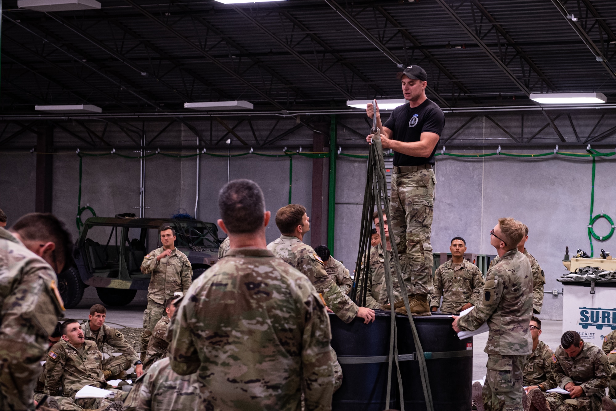 A U.S. Army Air Assault instructor teaches students the proper techniques on preparing equipment and supplies for sling load operations August 6, 2022, in Annville, Pennsylvania.