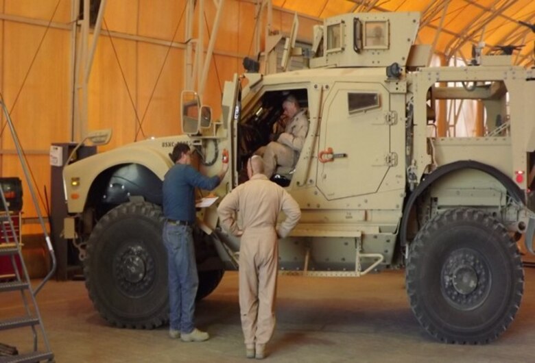 MAP-K contractors and MEU personnel conduct a joint limited technical inspection of an M-ATV prior to issuing while at Camp Arifjan, Kuwait.