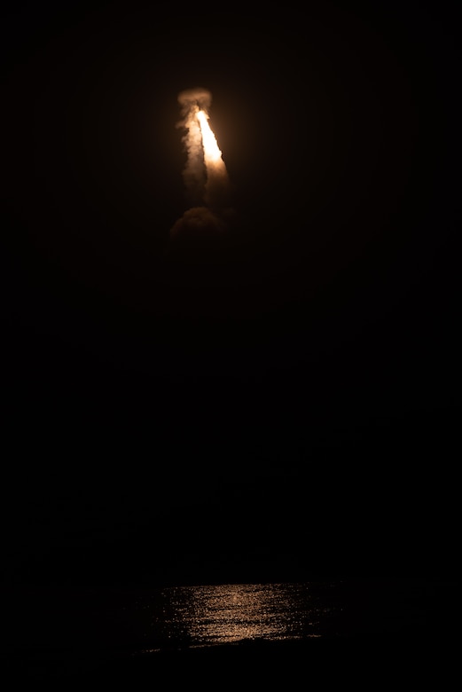 A missile launches at night.