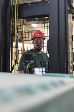 Corey Roach, 9th Logistics Readiness Squadron Materiel Handler, looks out over crates of extreme cold weather gear to ship out