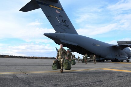 Alaska Air and Army National Guardsmen return to Fairbanks, Alaska, Sept. 30 from assisting Nome community residents affected by the remnants of Typhoon Merbok. The Alaska Joint Task Force members removed more than 180,000 pounds of storm-related debris and logged more than 3,000 work hours across 32 communities. (Alaska National Guard photo by Senior Master Sgt. Julie Avey)