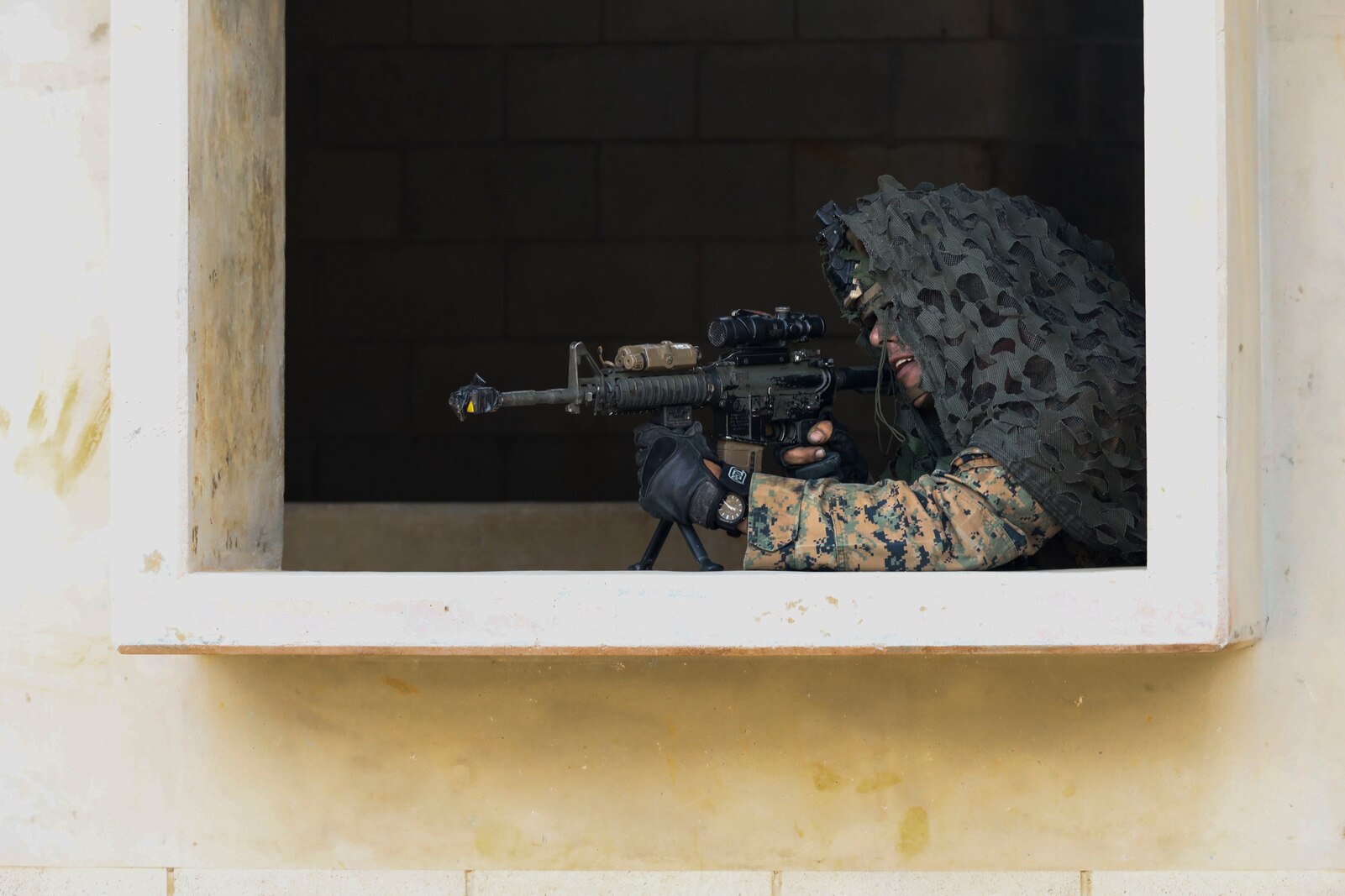 A U.S. Marine with 1st Battalion, 3d Marines, 3d Marine Division, participates in an assault during a force-on-force field training exercise with 3d Battalion, 12th Marines, aboard Camp Hansen, Okinawa, Japan, March 17, 2022.