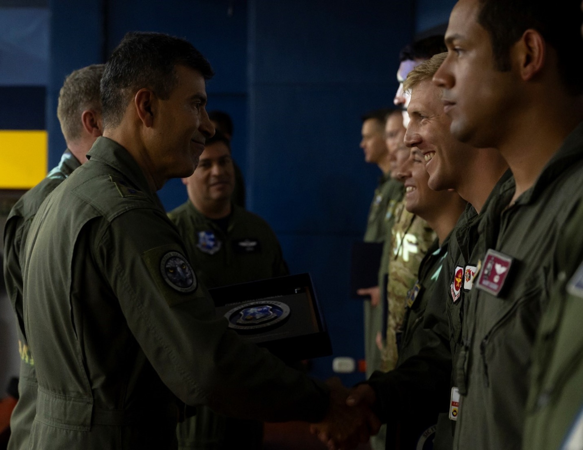 Colombian Air Force officers and United States Air Force Airmen standing across from each other in lines