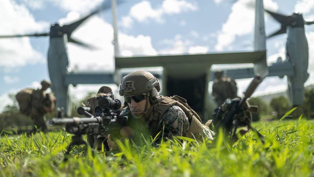 U.S. Marine Corps Sgt. Spencer Blum, an infantryman with 3rd Littoral Combat Team, 3d Marine Littoral Regiment, 3rd Marine Division, sets security with an M240B machine gun as part of exercise Bougainville II at Dillingham Airfield, Hawaii, Oct. 25, 2022. A company with 3rd Littoral Combat team secured an expeditionary advanced base at Dillingham Airfield in order to enable early warning of air and missile threats. Bougainville II is a field exercise that allows the MLR and its subordinate units to conduct expeditionary advanced base operations across the island of Oahu. BVII displays the MLR’s ability to rapidly establish and displace EABs while executing command and control in a dispersed environment.
