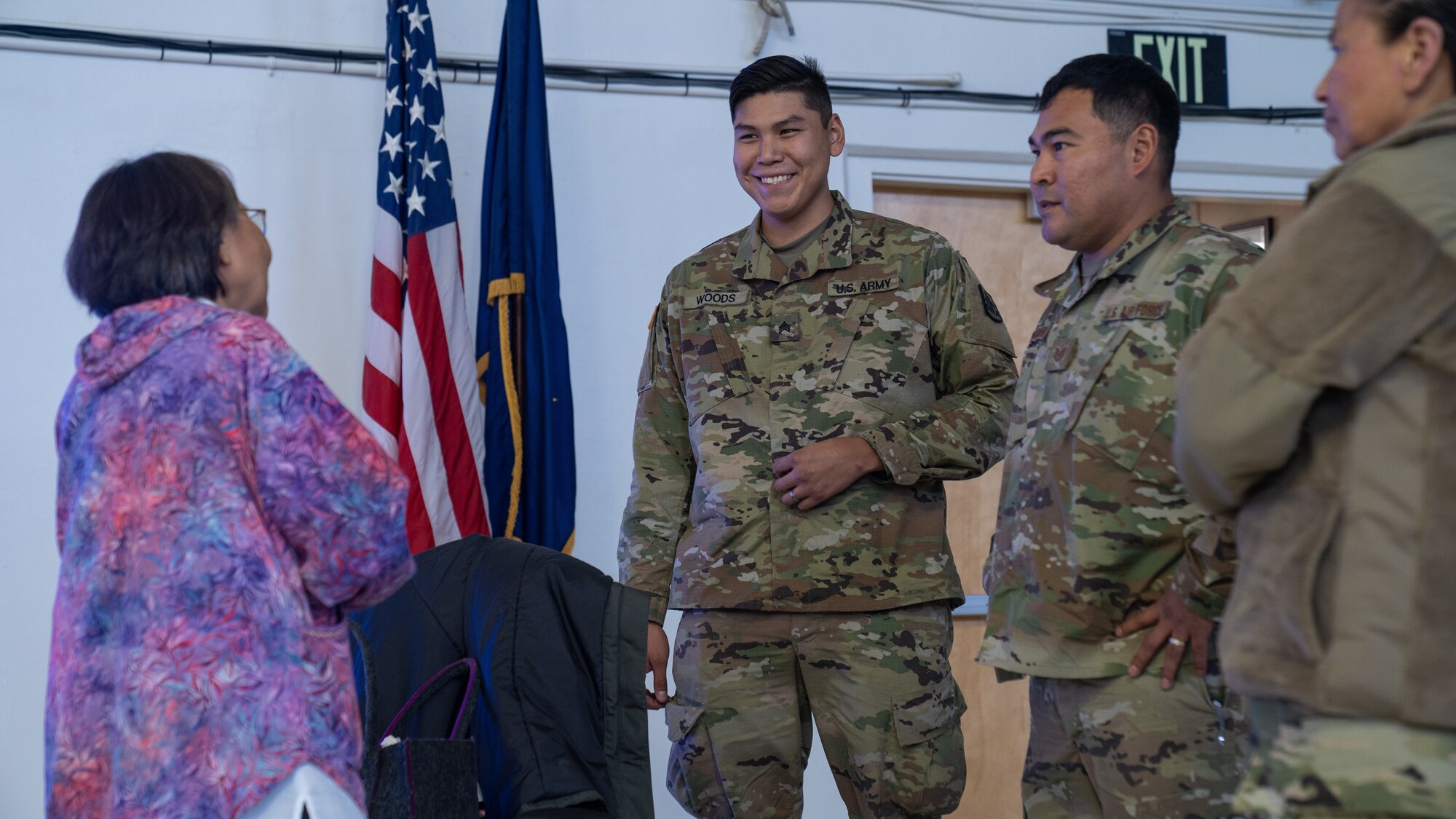 Bernedette Alvanna Stimpfle, director of the Alaska Native Language Preservation and Advisory Council, reunites with Sgt. Dempsey Woods and Tech Sgt. Blassi Shoogukwruk, former students of hers, during Operation Merbok Response, Sept. 21, 2022. Soldiers and Airmen of Joint Task Force-Nome during Operation Merbok Response, Sept. 21, 2022. More than 130 members of the Alaska Organized Militia, which includes members of the Alaska National Guard, Alaska State Defense Force and Alaska Naval Militia, were activated following a disaster declaration issued Sept. 17 after the remnants of Typhoon Merbok caused dramatic flooding across more than 1,000 miles of Alaskan coastline. (Alaska Army National Guard photo by Pfc. Bradford Jackson)