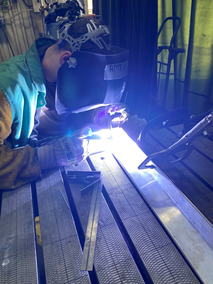 Project Arc Engineer 1st Lt. Andrew Foor welds together supporting parts for the hardening of a low-cost threat emitter Oct. 18, 2022, at Luke Air Force Base, Arizona. Foor, an electrical engineer by trade, worked with his teammate to help Luke Air Force Base modernize its ranges with emerging, high-impact technologies. (U.S. Air Force photo)