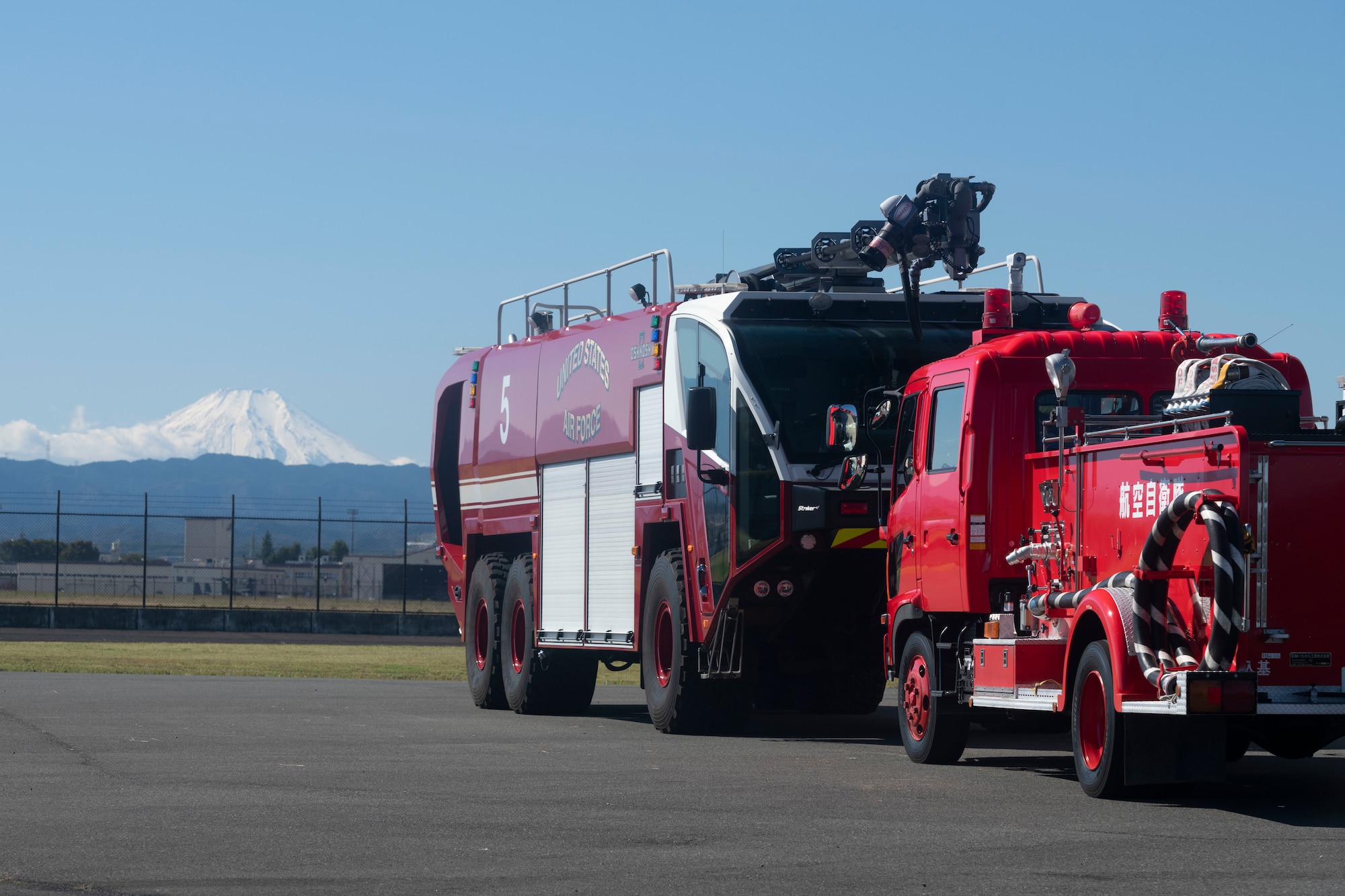 Fire trucks assigned to the 374th Civil Engineer Squadron and Japanese Air Self-Defense Force are parked in the training area during a bilateral training with the Japan Air Self-Defense Force at Yokota Air Base, Japan, Oct. 26, 2022.