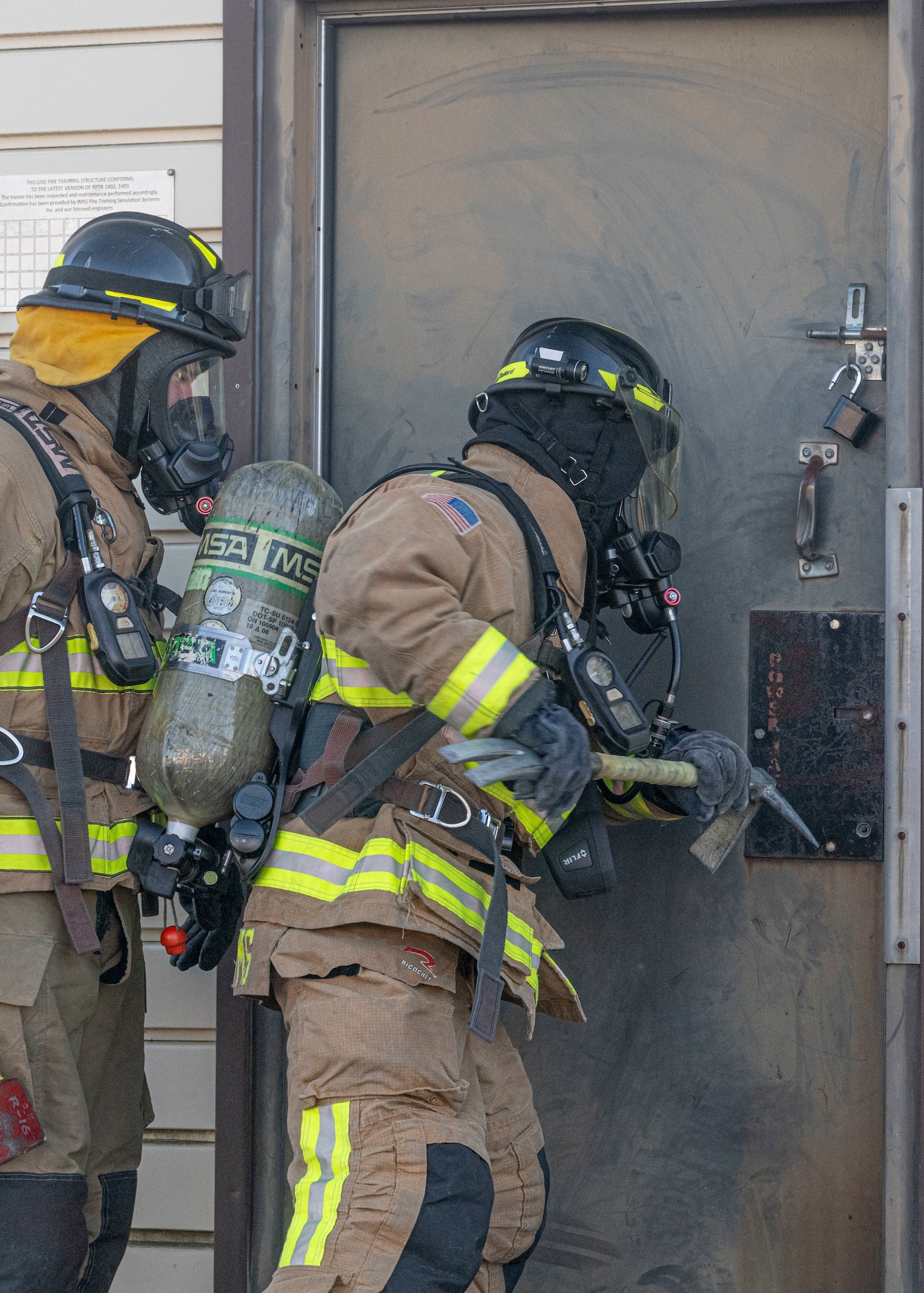 Senior Airman Anthon Williams, 374th Civil Engineer Squadron fire truck operator, opens a door with a halligan breaching tool during a bilateral training with the Japan Air Self-Defense Force at Yokota Air Base, Japan, Oct. 28, 2022.