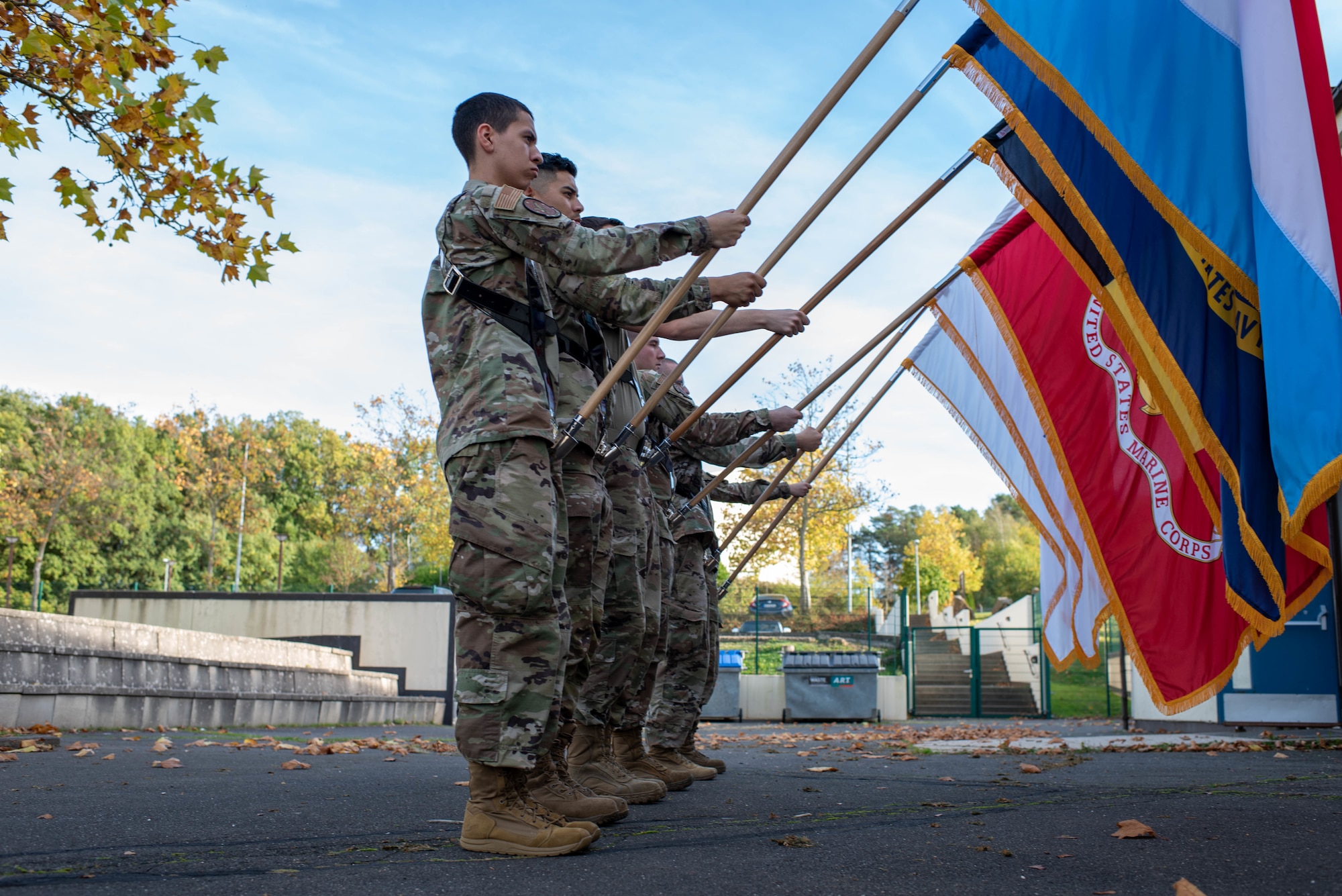 Base honor guard Airmen hold flags.