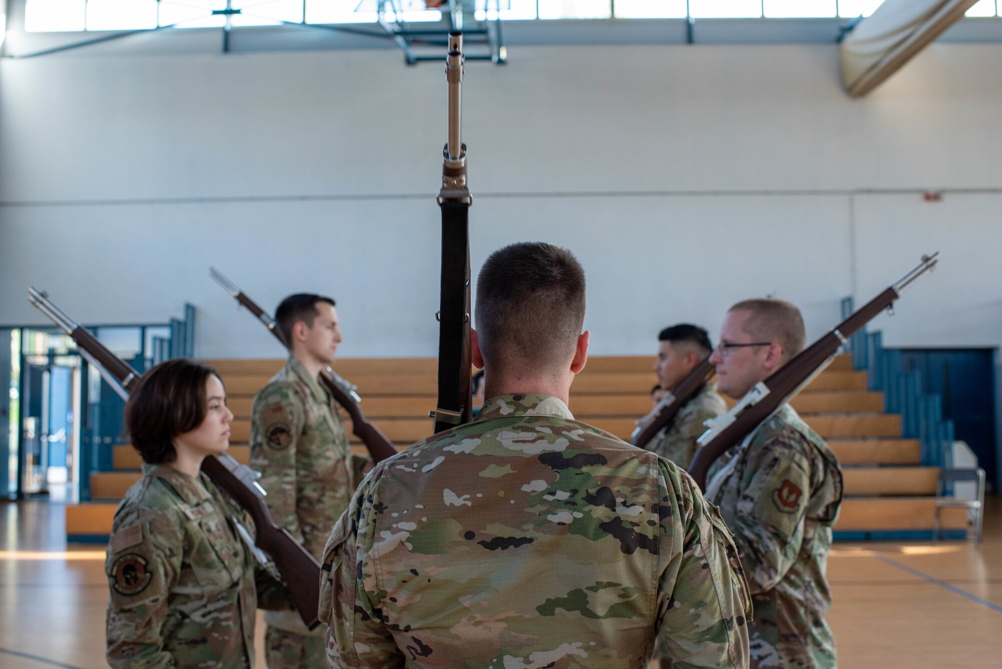 Base honor guard Airmen practice rifle positions.