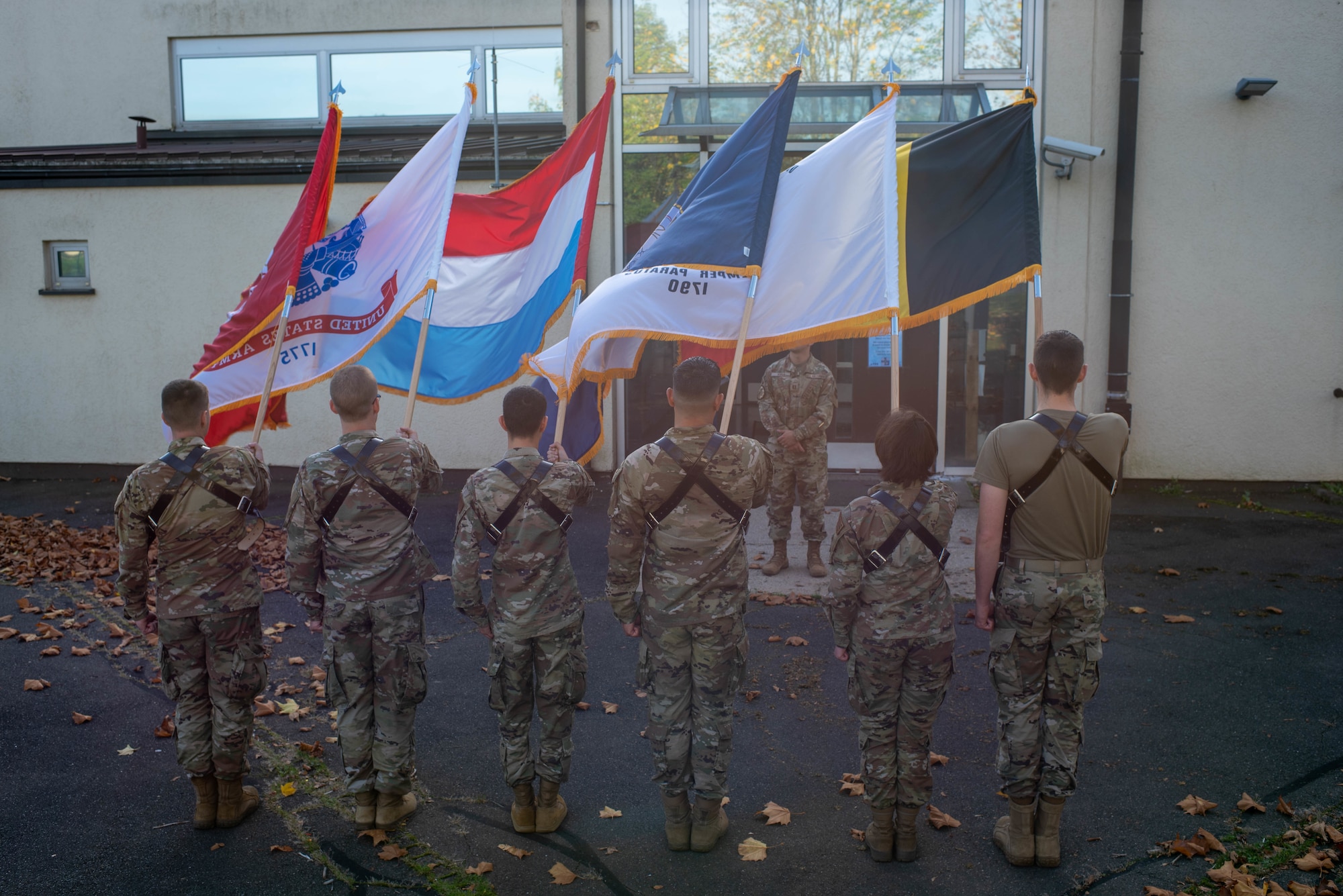 Base honor guard Airmen present flags at a practice.