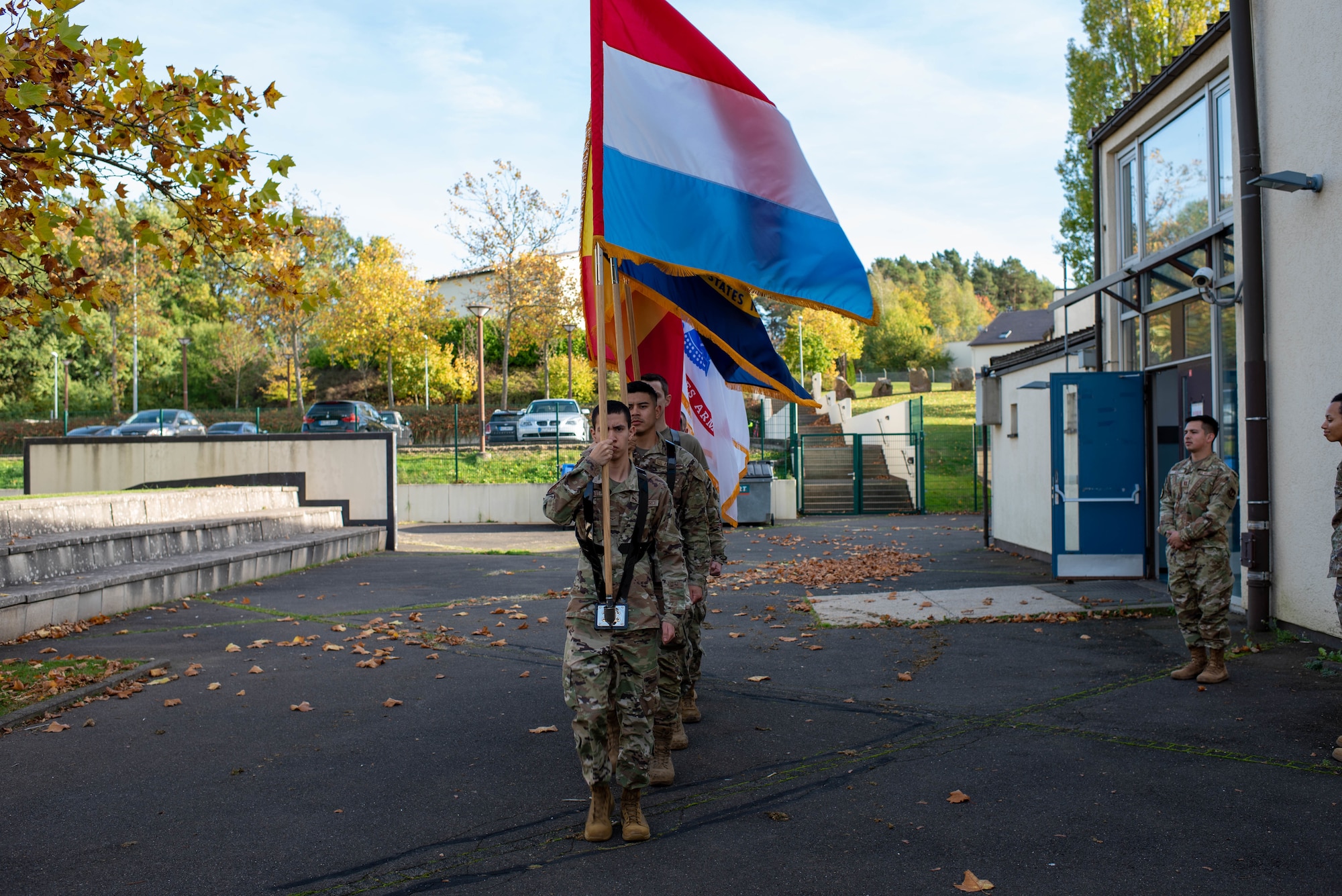 Base honor guard Airmen hold flags.