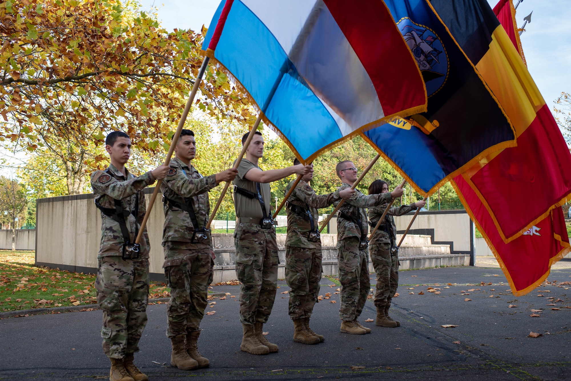 Base honor guard Airmen hold flags.
