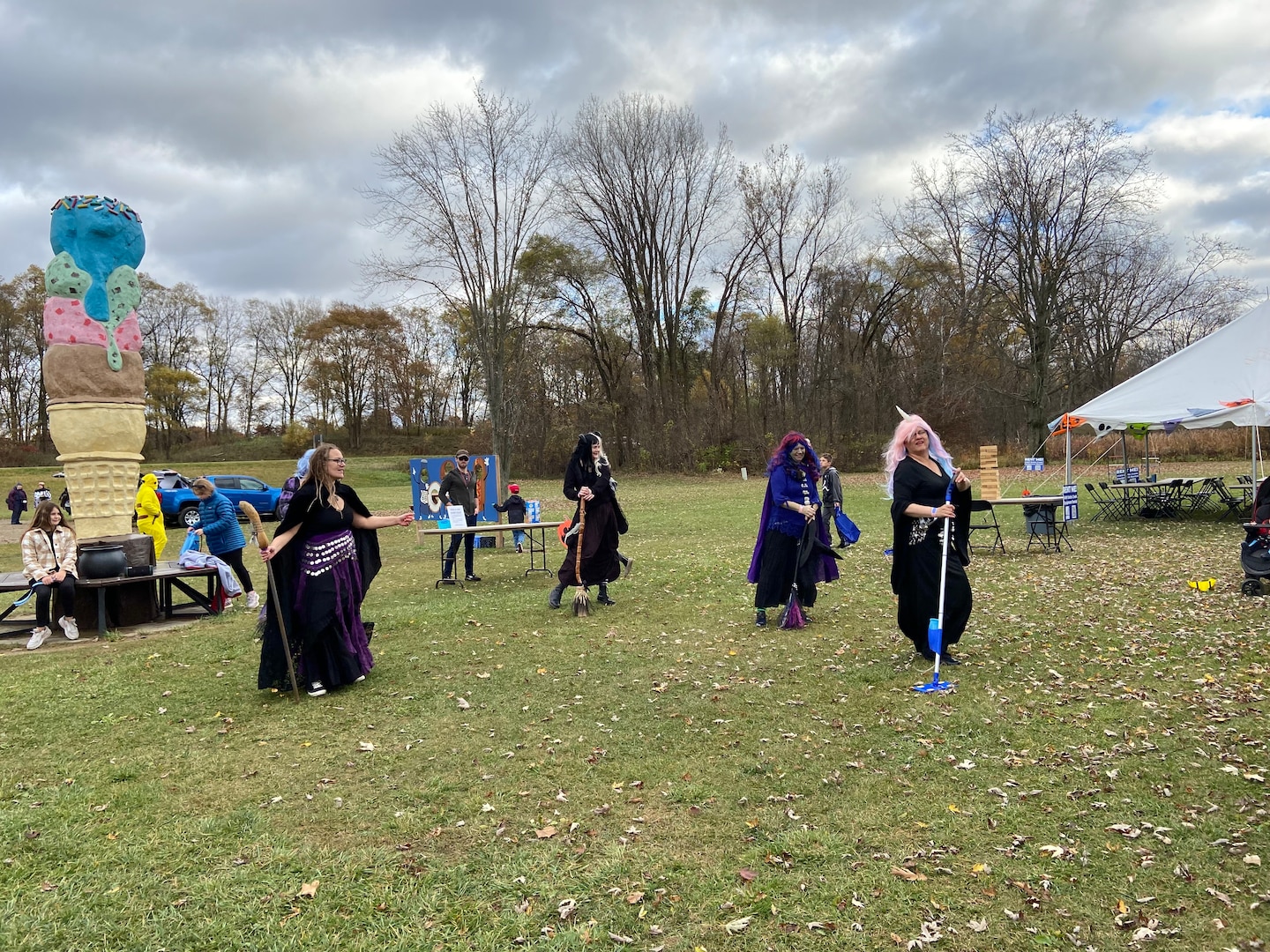 Group dressed as witches dancing with brooms.