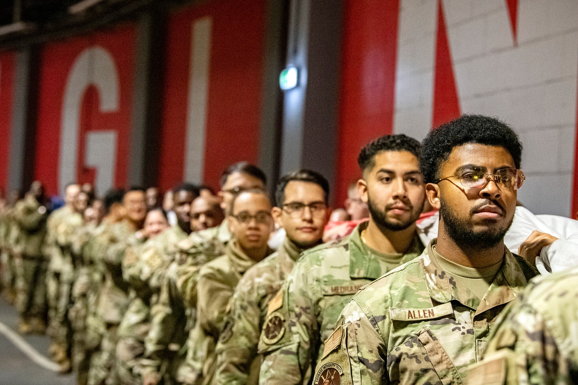 Airmen from the 501st Combat Support Wing hold an American flag prior to rehearsal for a national anthem demonstration at Wembley Stadium, in London, England, Oct. 30, 2022. Approximately 70 uniformed personnel represented the U.S. Air Force and nation by unveiling an American flag during the pre-game ceremonies of the Jacksonville Jaguars and Denver Broncos NFL game. (U.S. Air Force photo by Staff Sgt. Eugene Oliver)